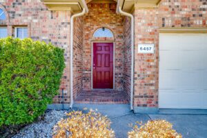 Texas property management for a Richardson Texas home that has a red door with brick structure.